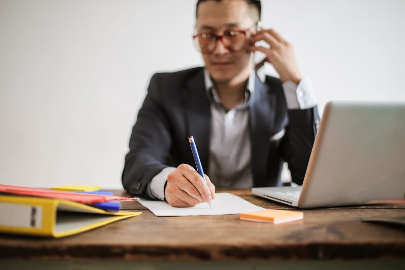 Professional using a smartphone to handle client documents