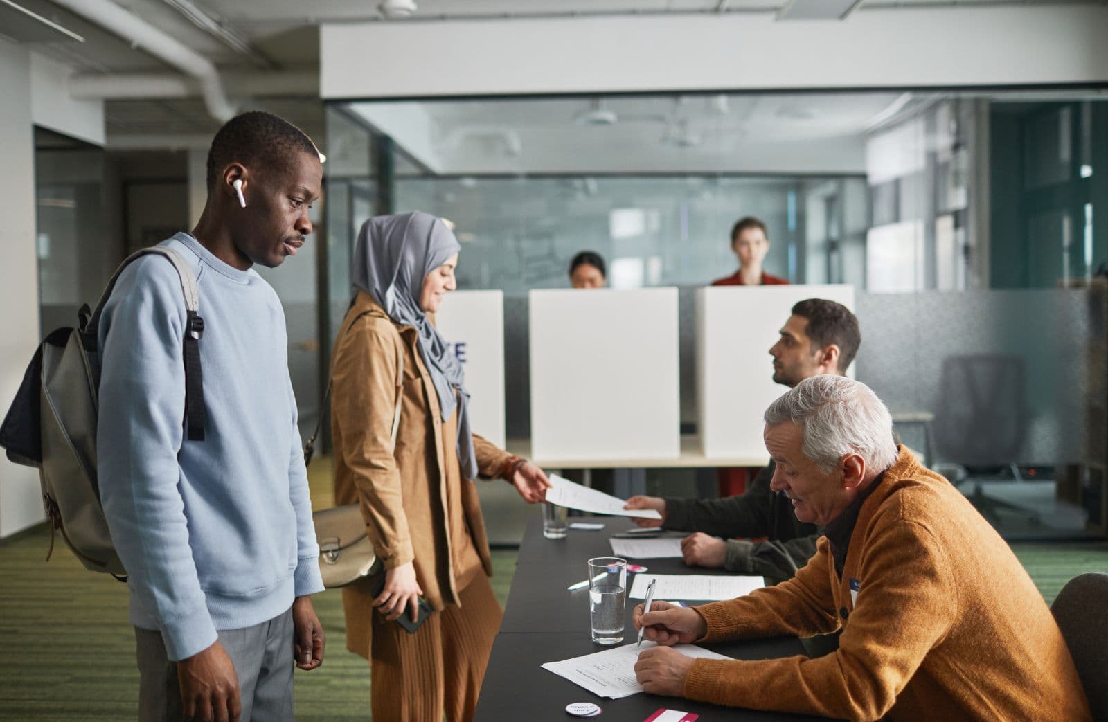 Government office clerk helping a citizen at a desk
